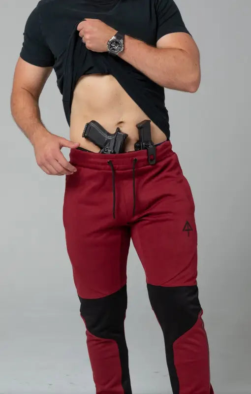 Red athletic pants with concealed carry holster and patented carrier retention waistband