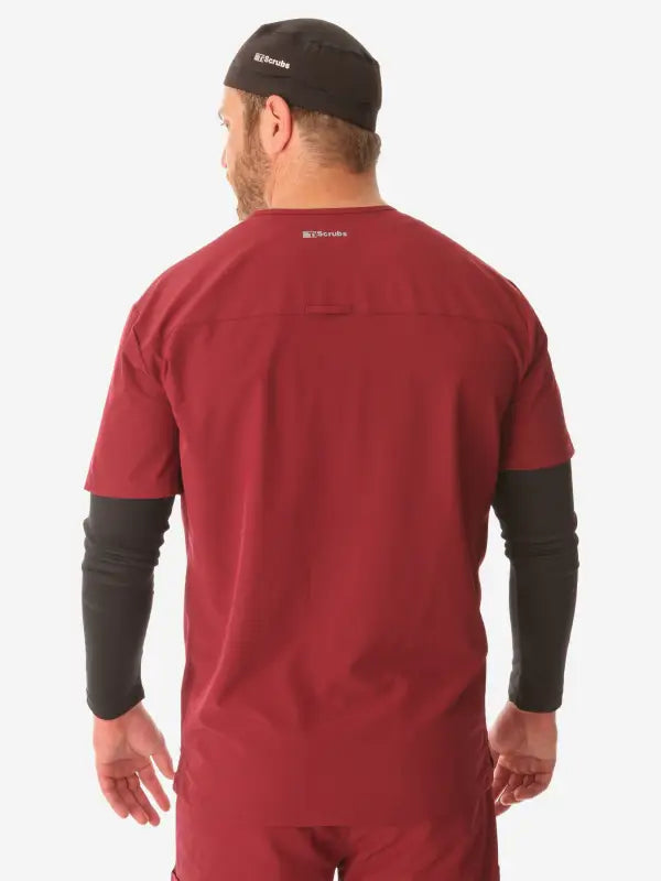 Red men’s long-sleeve underscrub with black long sleeves worn backwards