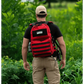 Red backpack with black stripes worn with outdoor gear, ideal for a Field Medic Kit