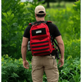 Red backpack with black stripes worn with outdoor gear, ideal for a Field Medic Kit