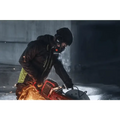 Red chainsaw creating sparks in winter, showcasing Husqvarna K 1 PACE battery powered cutter