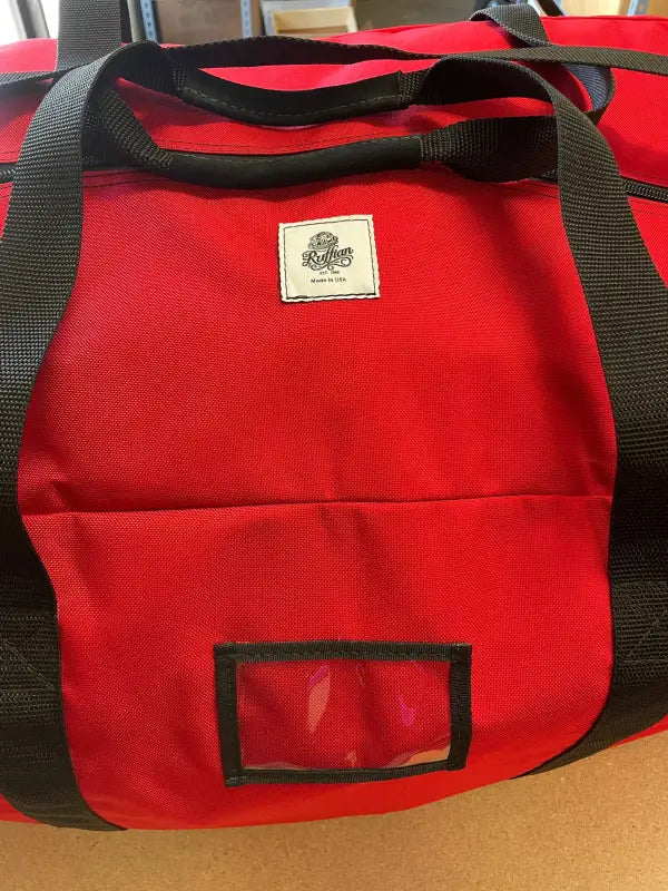 Red duffel bag with black straps for Academy Turnout Bag and turnout bag storage
