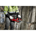 Red Milwaukee 2727-20C M18 FUEL™ 14’’ Chainsaw cutting through a tree trunk
