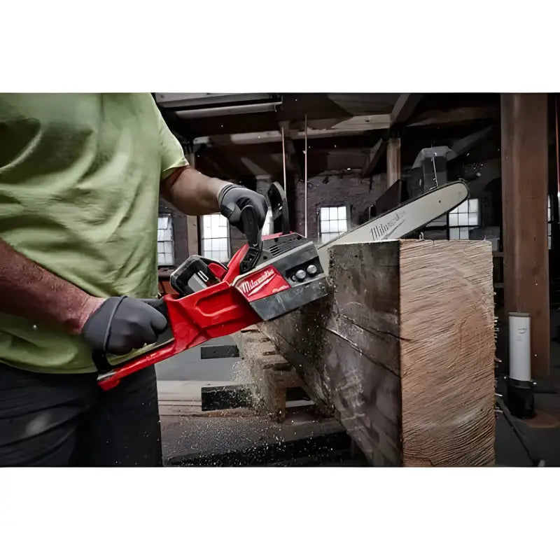 Red electric Milwaukee 2727-20C M18 FUEL™ 14’’ Chainsaw cutting through a wooden beam