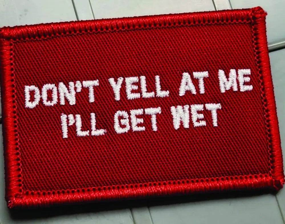 Red embroidered patch with white text reading Don’t Yell At Me I’ll Get Wet - 2x3 patch