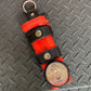Red flashlight with black leather straps in THE MINIMALIST Leather Inverted Flashlight Holder