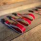 Red hair clippers for first responders with glove straps lined up in a row