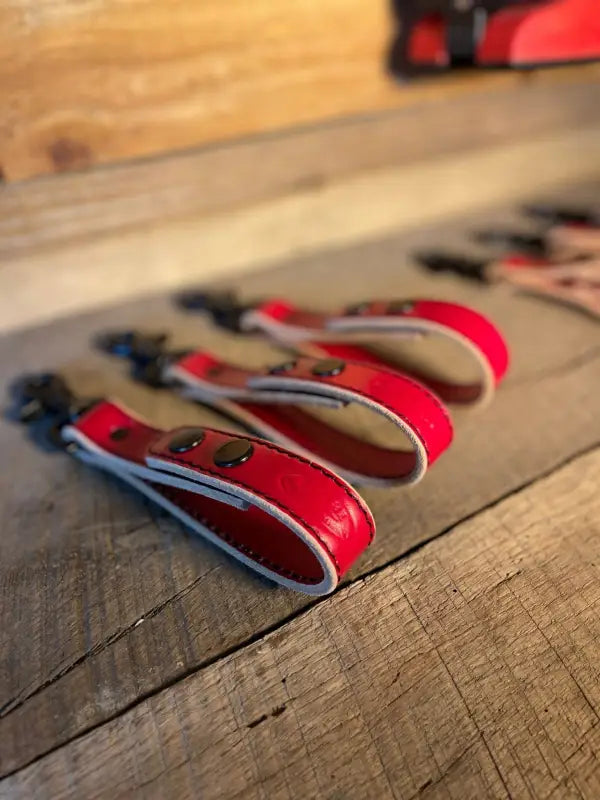 Red hair clippers for first responders with glove straps lined up in a row