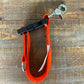 Red climbing harness with metal carabiner for glove strap used by first responders