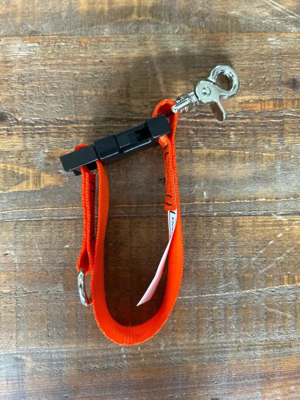 Red climbing harness with metal carabiner for glove strap used by first responders