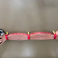 Red fire hose with yellow straps and metal connectors in Adjustable Hose Bundle Strap Kit