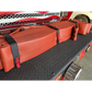 Red fire hose rolls secured with black straps on textured surface for Hose Strap 44”-FF44HS