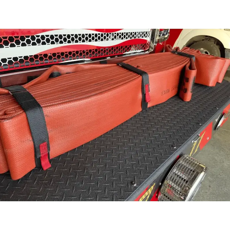 Red fire hose rolls secured with black straps on textured surface for Hose Strap 44”-FF44HS