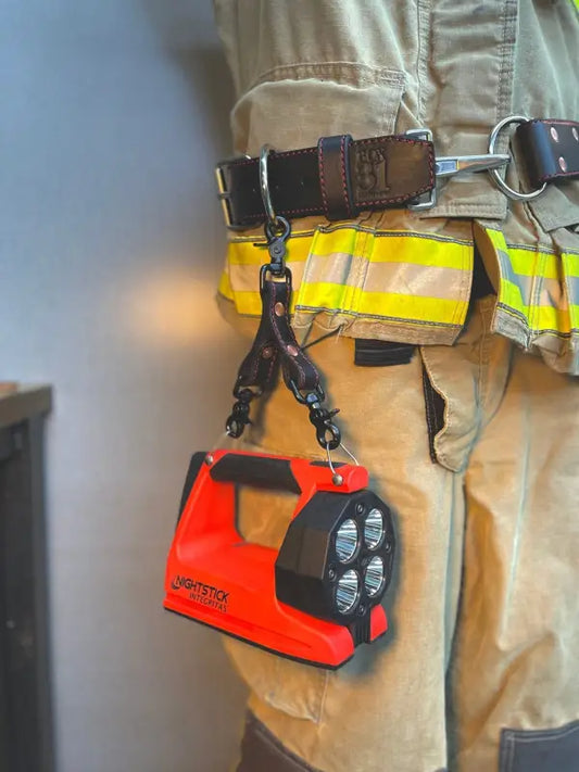 Red LED spotlight on a utility belt showcasing the Box Light Clip in med brown