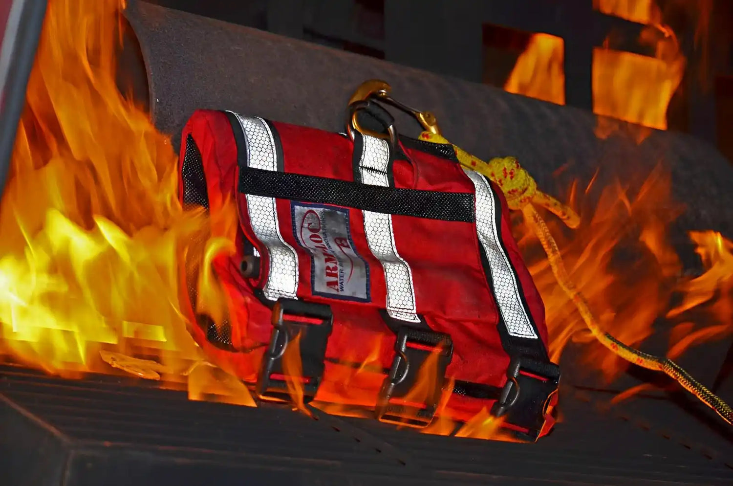 Red life jacket with reflective white stripes and black buckles.