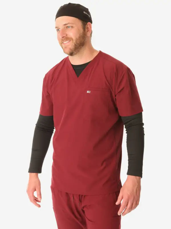 Red medical scrub top with black long sleeves, ideal for men’s scrub cap style