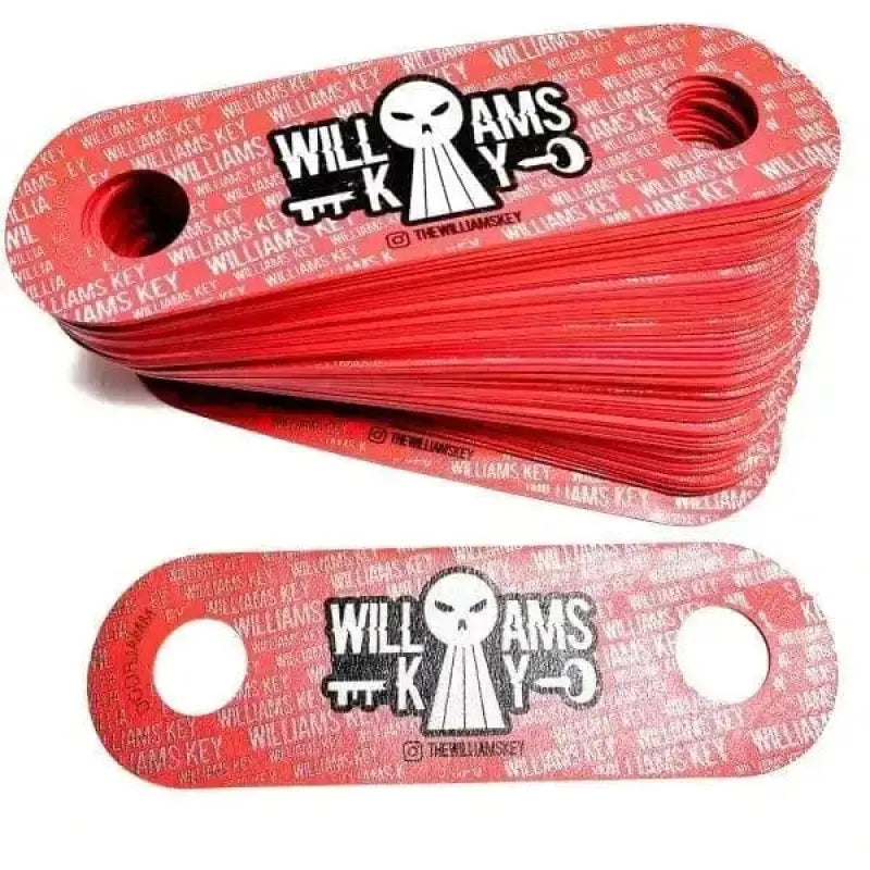 Red metal shackle plates with Williams branding for Key X DOORJAMM designed for first responders