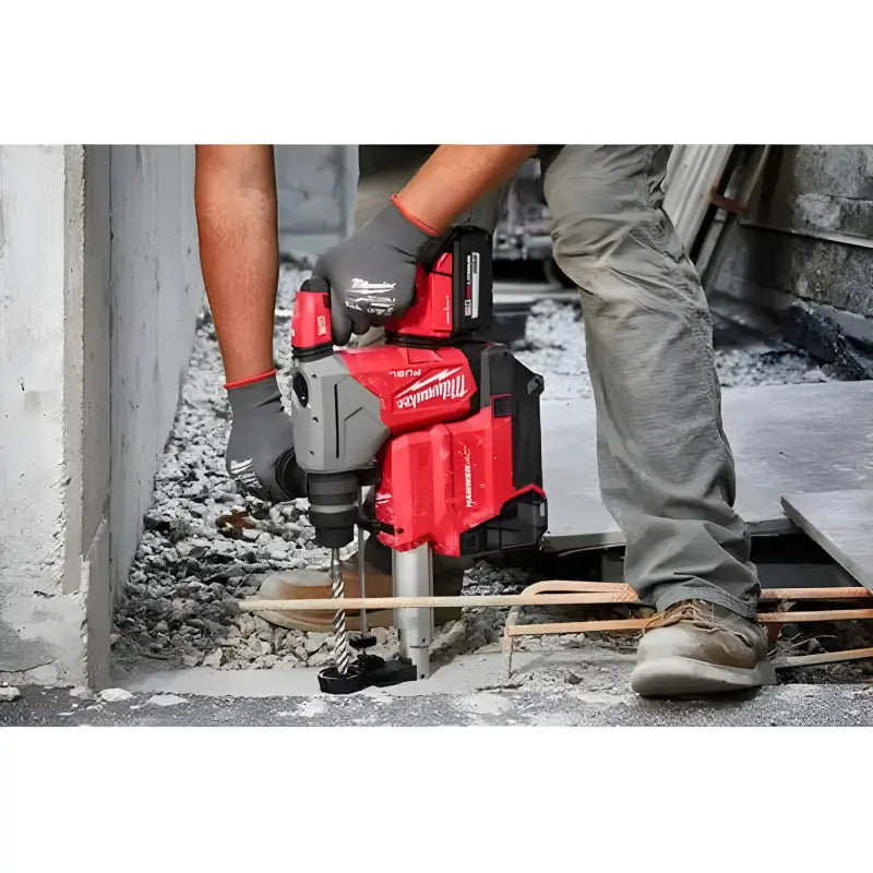 Red Milwaukee 2915-20 M18 Fuel rotary hammer breaking through concrete