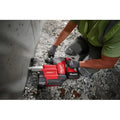 Red Milwaukee 2915-20 M18 FUEL 1-1/8’’ SDS Plus Rotary Hammer drilling into concrete