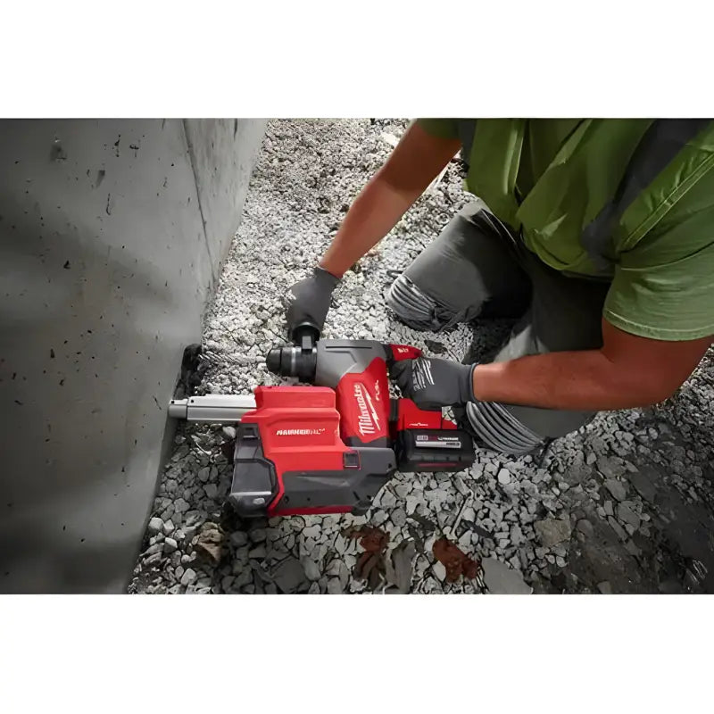 Red Milwaukee 2915-20 M18 FUEL 1-1/8’’ SDS Plus Rotary Hammer drilling into concrete