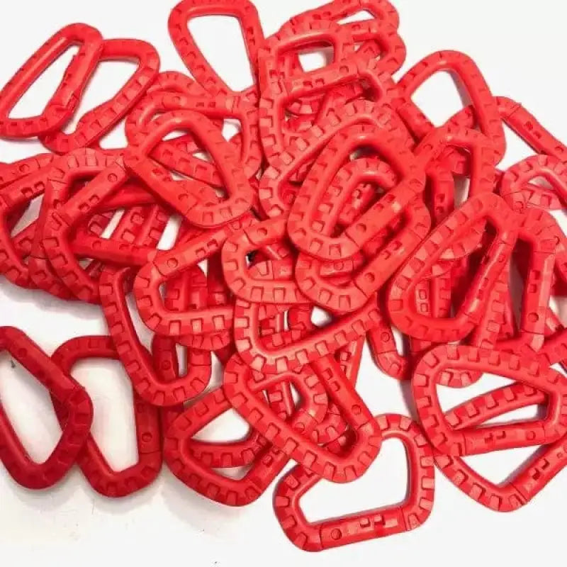 Red plastic Tactical Carabiners scattered in a pile for first responders use