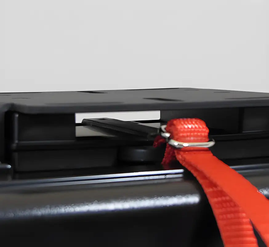 Red plastic ratchet strap secured to Aluminum Quick Release Mounting System by Outer Limit Supply