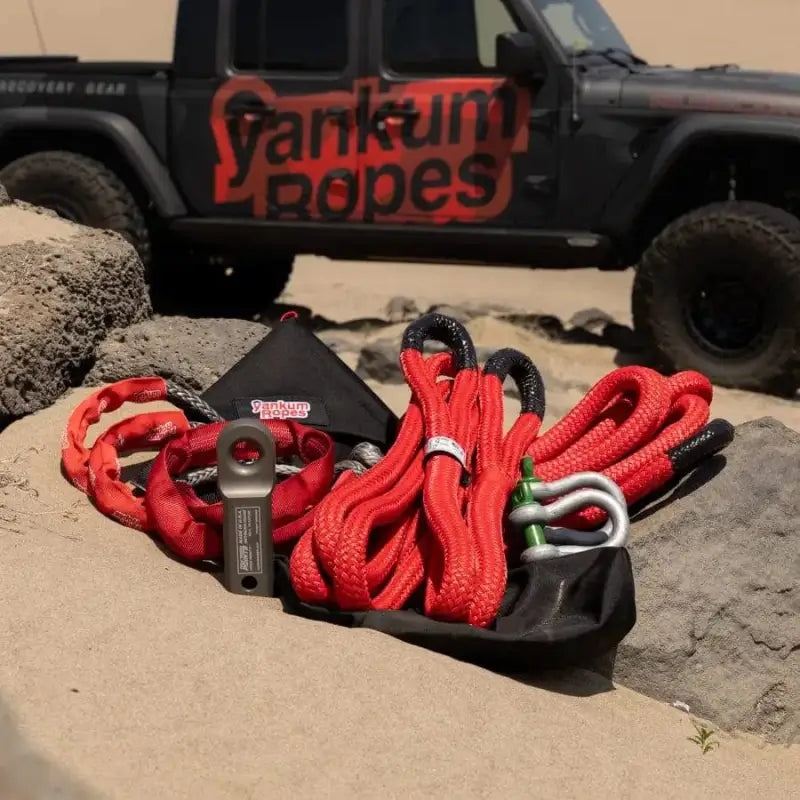 Red kinetic recovery rope and gear on rocks for Off-Road Recovery Kit