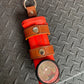 Red survival signal flare with leather straps in THE MINIMALIST Leather Inverted Flashlight Holder