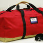 Red and tan turnout gear bag with center zipper for durable gear storage