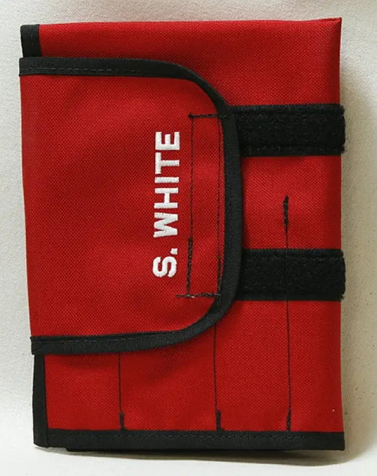 Red firefighter turnout tool roll with black trim for carrying turnout tools and firefighting gear