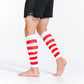 Red and white striped calf compression sleeves worn on bare legs for stylish support