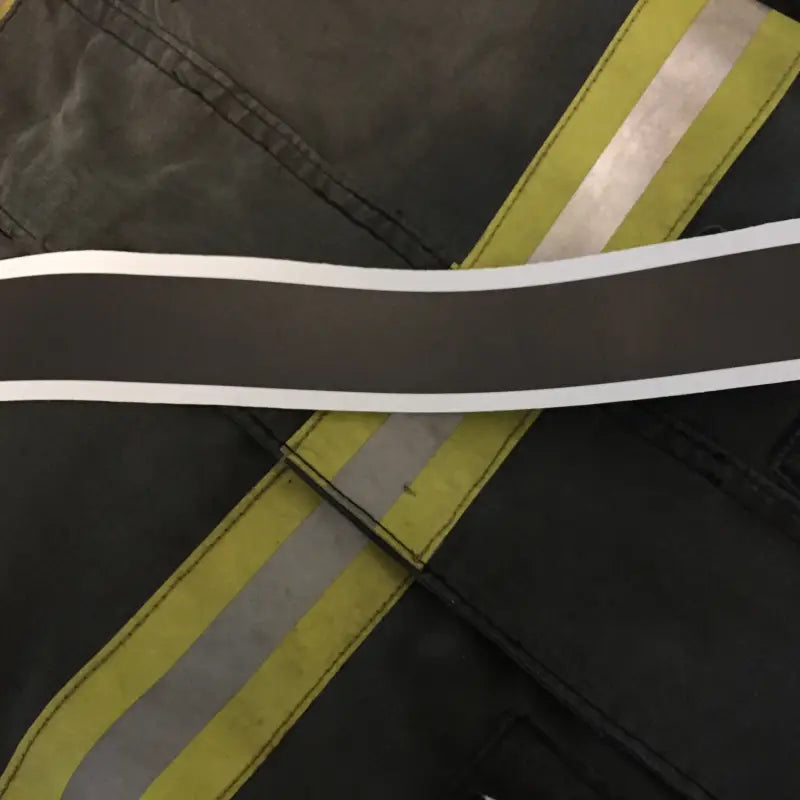 Reflective yellow and silver safety strip on Matte Black Reflective Helmet Trim fabric