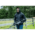 Black tactical rifle with optics and accessories next to Rendition Jacket Elite’s smart pockets