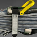 Rolled fire hose with nozzle and strap featuring FRE Adjustable Hose Strap in white reflective Condura