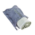 Rolled newspaper in gray plastic bag with Israeli 4” Compression Bandage product