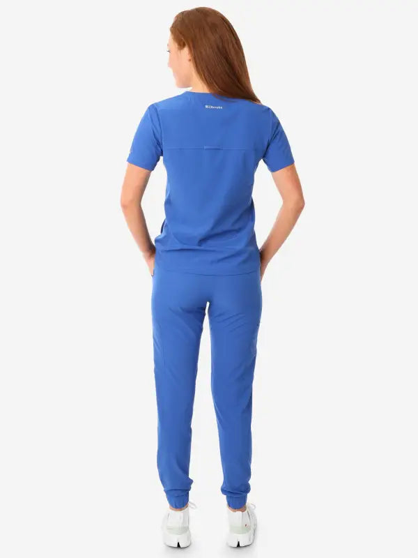 Royal blue women’s stash-pocket scrub top with short sleeves and jogger-style pants