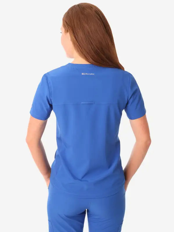 Royal blue women’s stash-pocket scrub top with short sleeves, view from back