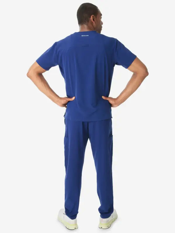 Royal blue men’s double-pocket scrub uniform with short sleeves and matching pants