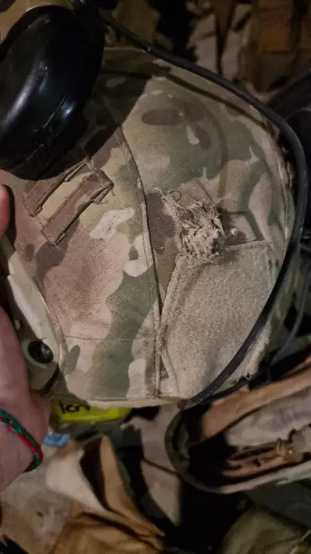 Camouflage military-style cap in desert pattern with RT2 Ballistic High Cut Helmet