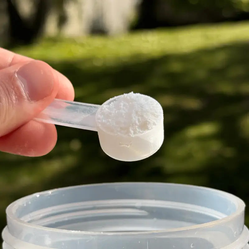 Scoop of white electrolyte powder for Orange Electrolytes to stay hydrated with high sodium