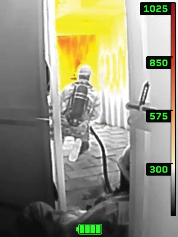 Thermal image of firefighter entering burning room with Seek FirePRO™ 300 high-resolution thermal imaging