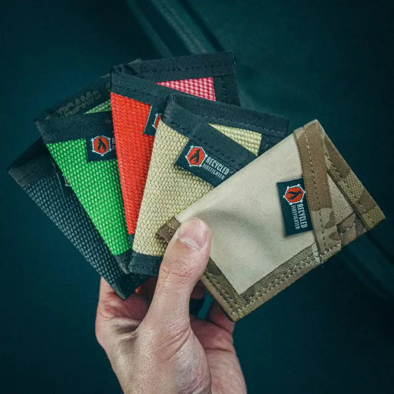 Hand holding colorful minimalist Sergeant Wallets in Coyote Leather and Combat Boot Leather