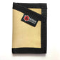 Tan canvas wallet with black trim and red logo patch in Coyote Leather design