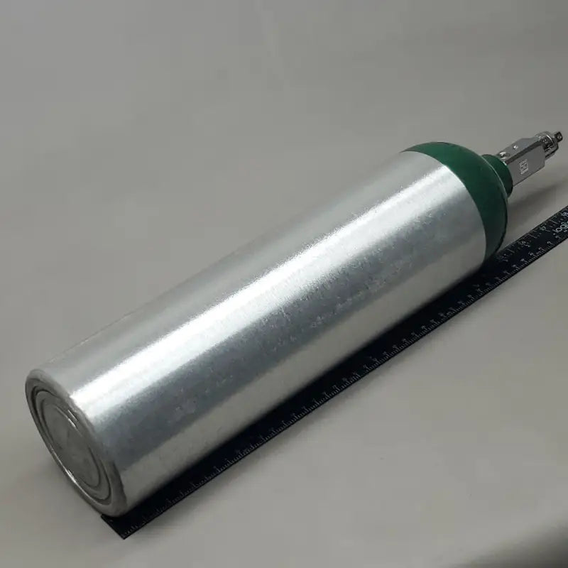 Silver medical oxygen cylinder with green cap and post valve nozzle tip