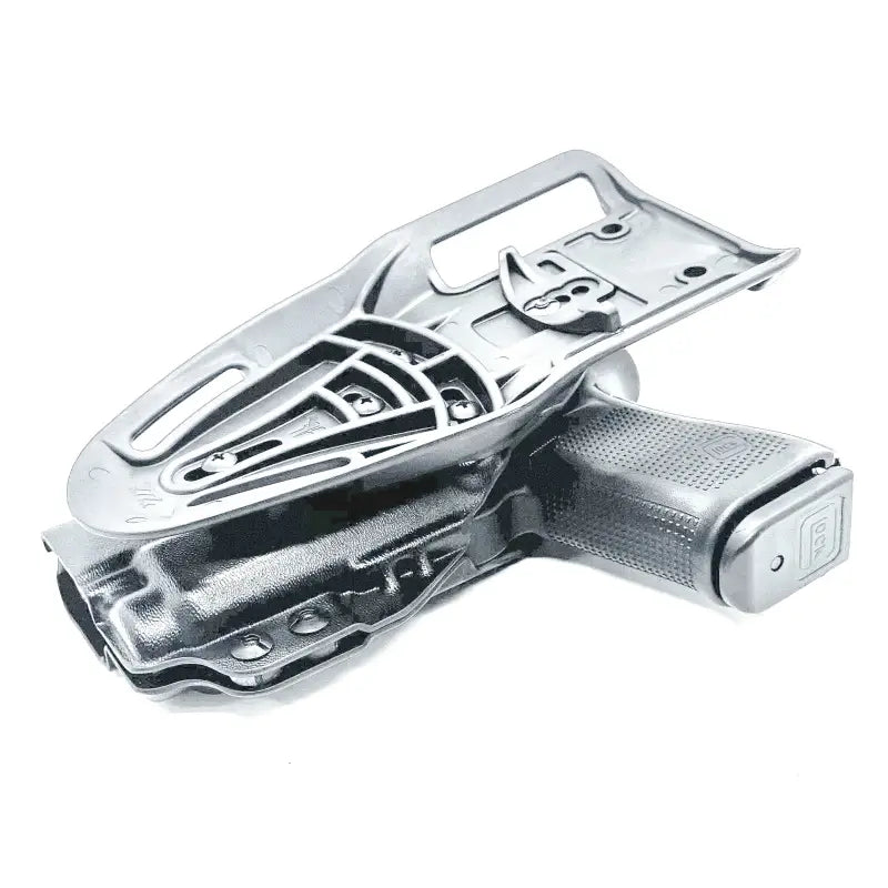 Silver pistol in holster with Nightstick TCM-10 and weapon lights for competition use