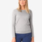 Simple grey long-sleeve underscrub sweater paired with navy blue pants for women