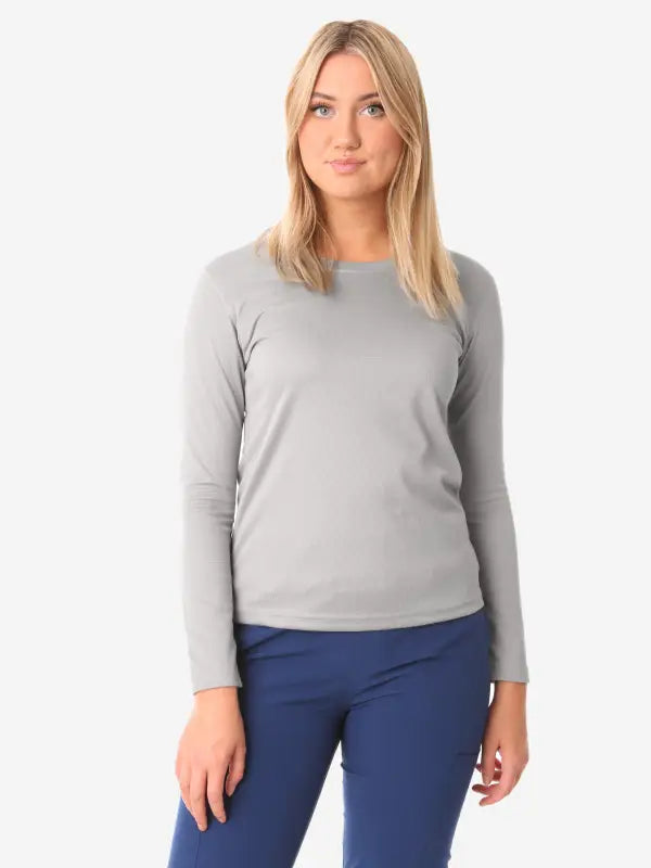 Simple grey long-sleeve underscrub sweater paired with navy blue pants for women