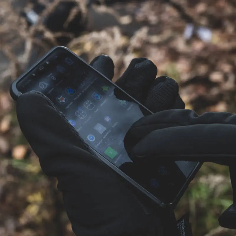 Smartphone in a black gloved hand featuring M-Tac Gloves Soft Shell Thinsulate