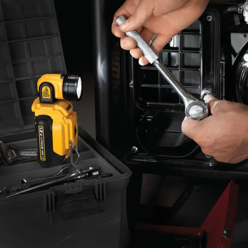 Socket wrench tightening a bolt with DEWALT DCL510 12V MAX LED Work Light in use