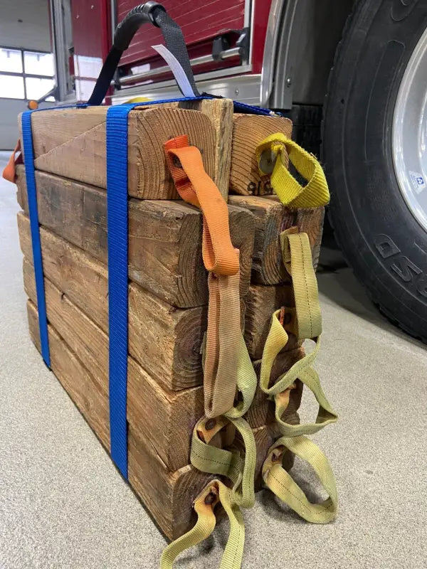 Stack of wooden blocks secured with blue cribbing strap Long-FFCS12 and yellow harnesses